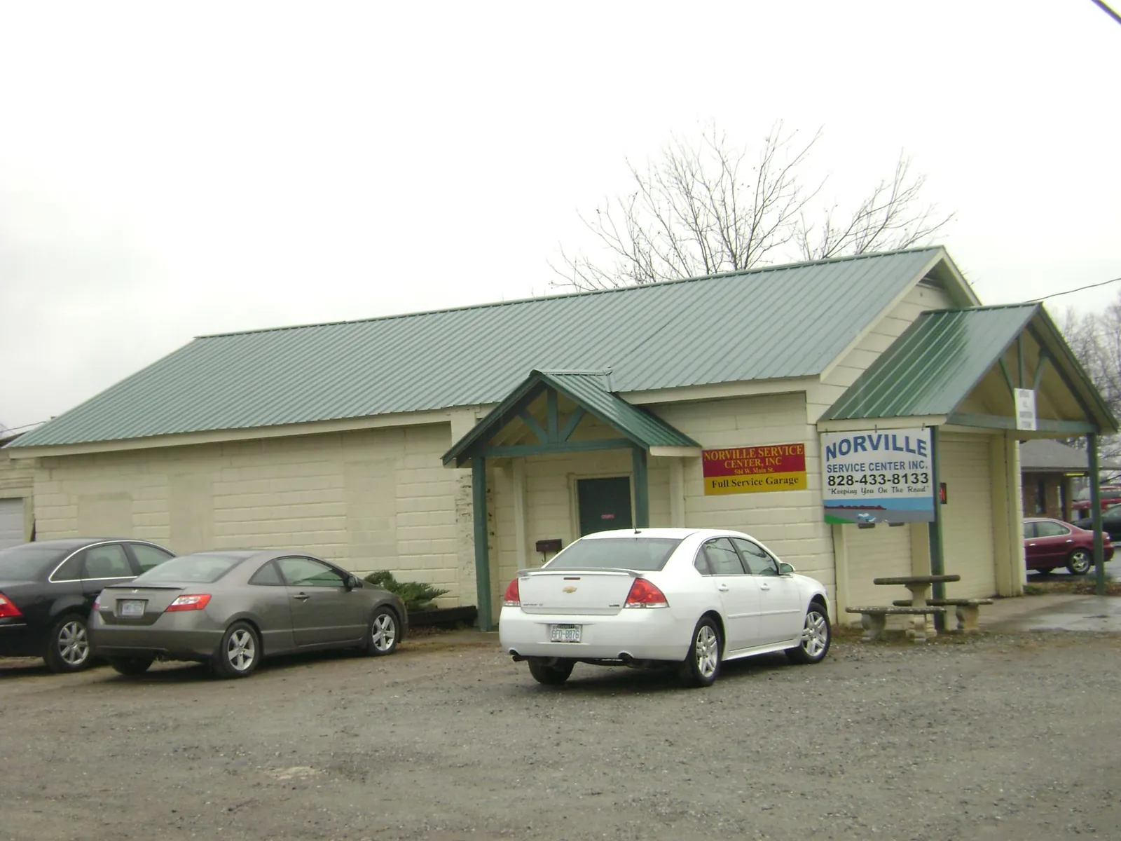 Green metal roof on a service garage with a covered entry in Lairdsville